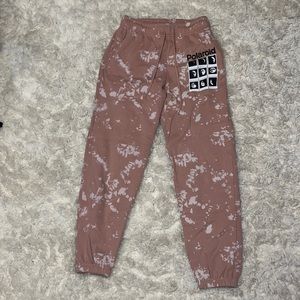 Primo and white tie die sweatpants with Polaroid pictures of the moon